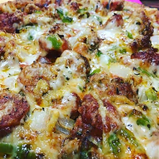 large pizza with cheese, vegetables and meat