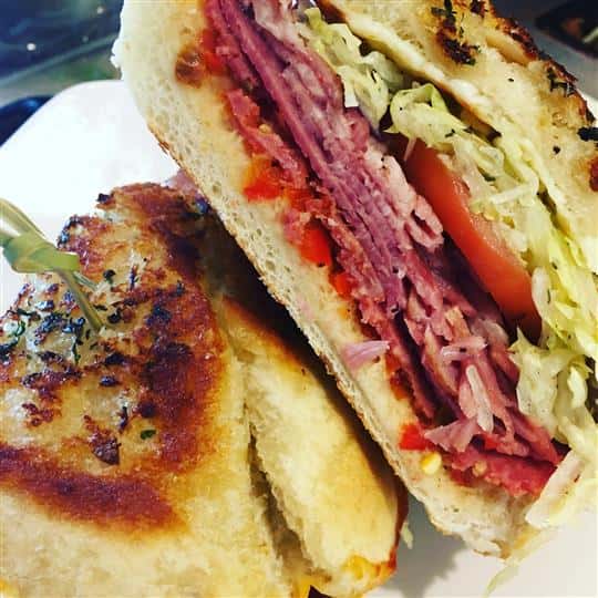 italian sandwich with meat, lettuce and tomato