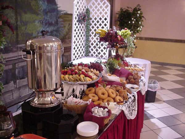 a dessert table with assorted fruits and pastries