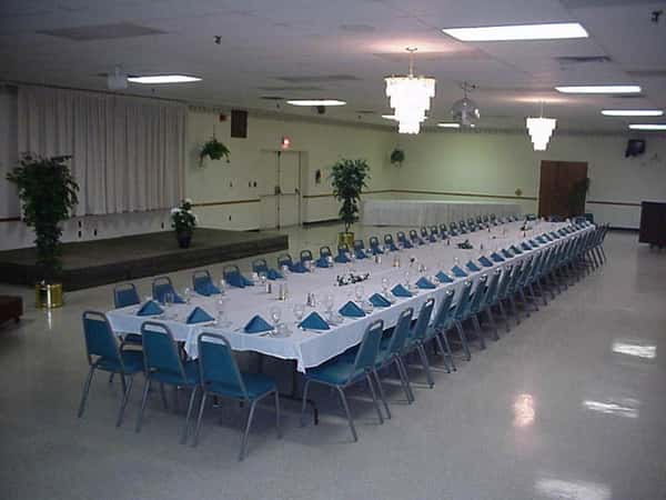 one very long rectangular table with several chairs