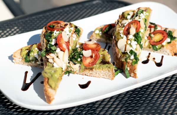 Toasted 9-Grain Wheat bread topped with guacamole, feta cheese, toasted almonds, grape tomatoes, fresh basil, and balsamic reduction.