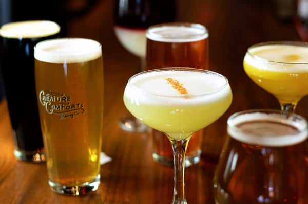 A variety of beers and cocktails on a table