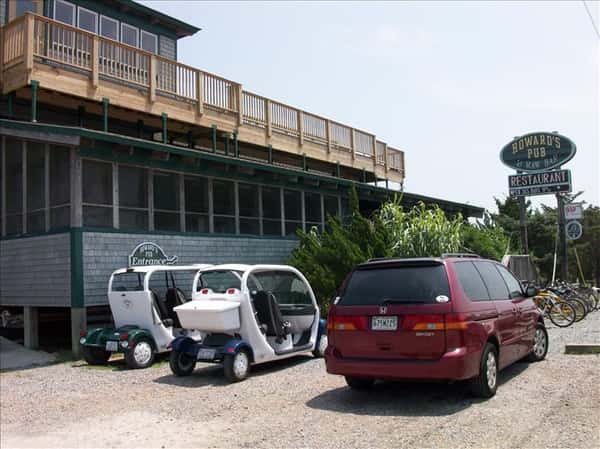 Golf carts and van parked outside Howard's Pub