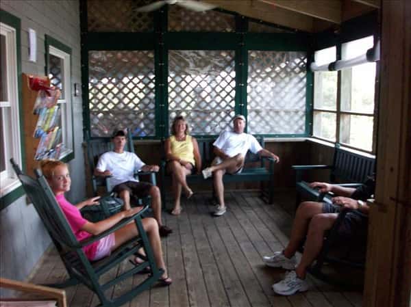 Family sits on chairs in patio area