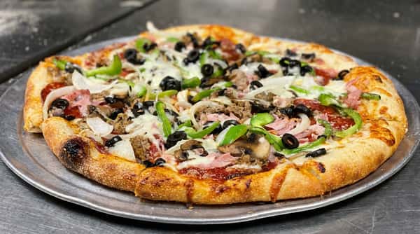 Large supreme pizza with black olives, green bell peppers, onions, mushrooms, sausage, and ham.