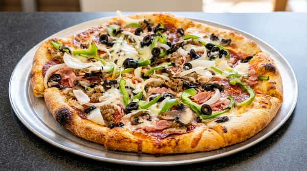 Large supreme pizza with black olives, green bell peppers, onions, mushrooms, sausage, and ham.