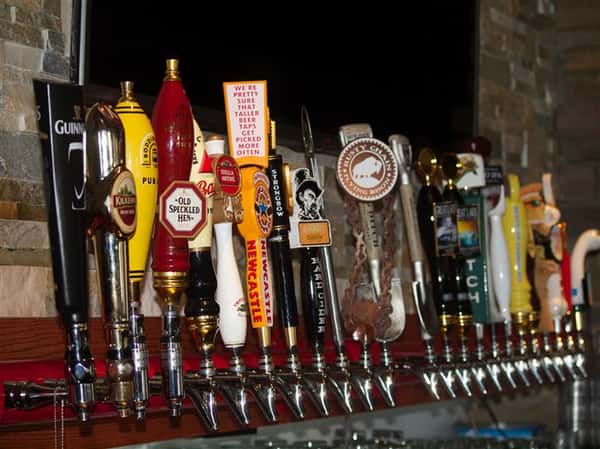 a row of beer taps at the bar