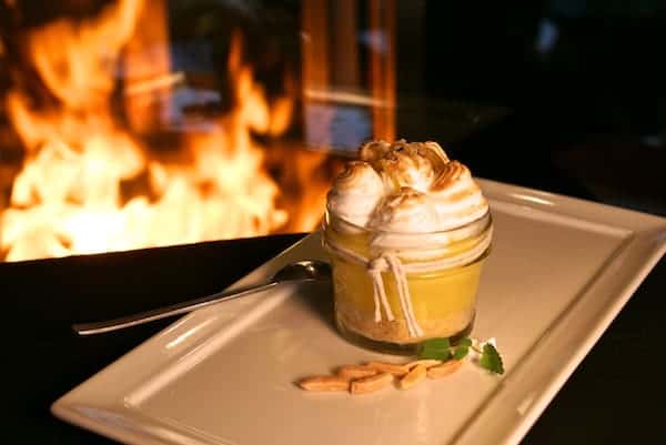 House-made lemon meringue in a jar, layered with graham cracker crust and topped with toasted peaks of fluffy meringue — a bright, tangy dessert perfect for citrus lovers and elegant sweet finishes.