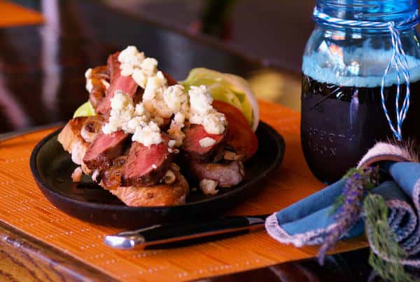 Tender grilled steak slices layered on toasted artisan bread, topped with crumbled blue cheese, sautéed mushrooms, and fresh tomato — a bold, savory twist on a classic steak sandwich.