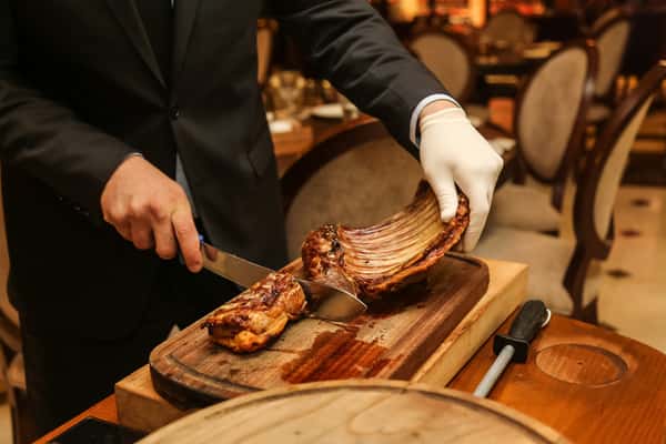 man cutting fried meat