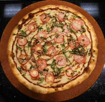 pepperoni pizza with fresh basil, melted mozzarella, and a lightly charred crust