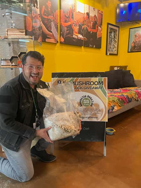 Customer holding back of Mycelium at Lazydaze South Austin