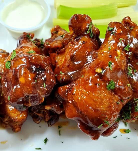 assortment of chicken wings topped with garnish