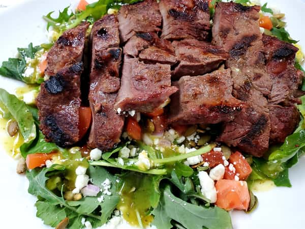 grilled steak salad with crumbled cheese and tomatoes