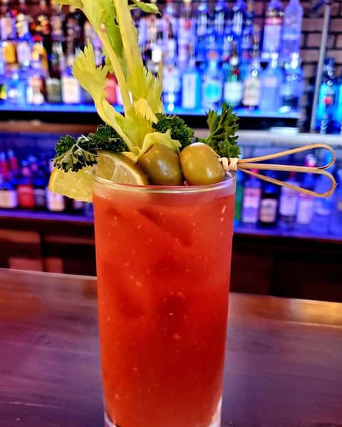 bloody mary with a stalk of celery and olives
