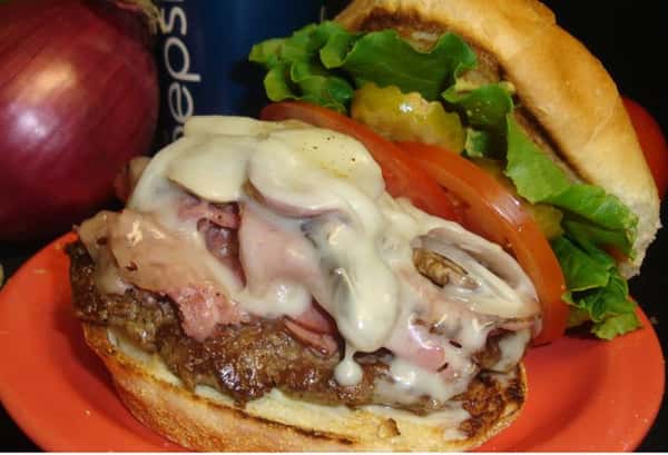 cheeseburger with lettuce, tomato, pickles and onions