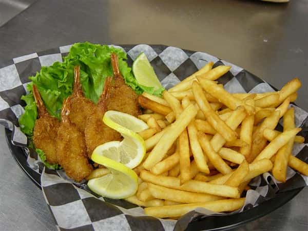 fried fish with lemon wedges and a side of french fries