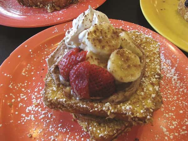 french toast topped with bananas and strawberries