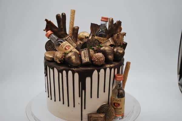 chocolate drip cake with assorted cookies and chocolates