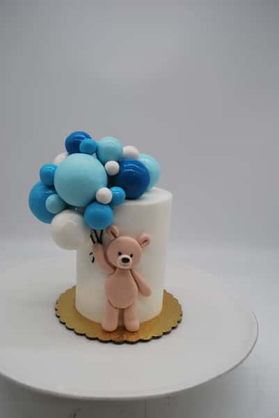 teddy bear with flowing balloons