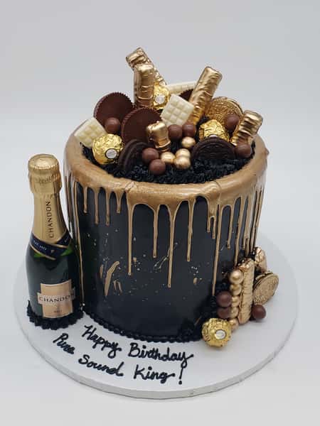 black with gold drip and assorted chocolates and champs