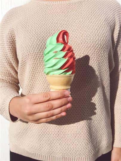 red and green ice cream swirled in a cone
