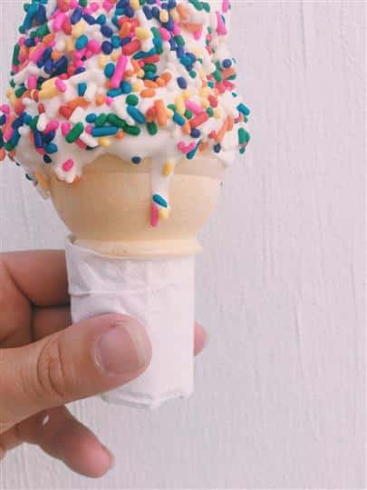 vanilla ice cream cone with rainbow sprinkles