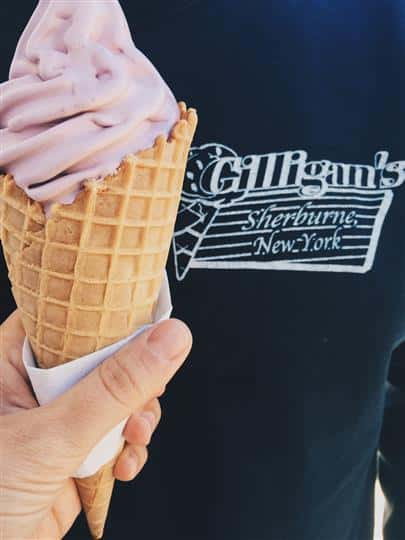 strawberry ice cream cone in front of a shirt with Gilligan's logo