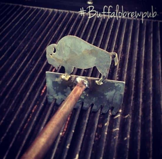 A metal bull grill scraper