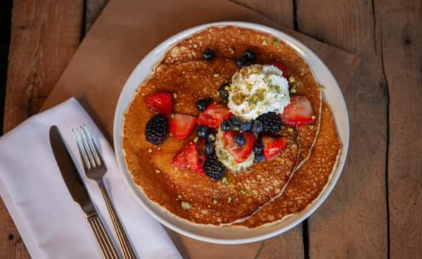 Pancakes topped with blueberries, strawberries and blackberries