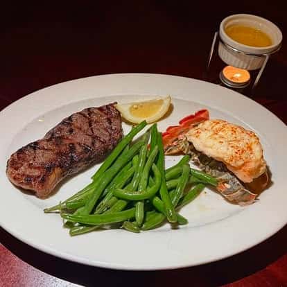 steak, green beans and salmon with sauces on the sides