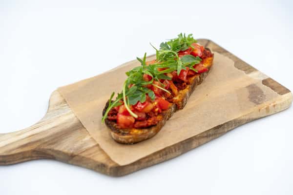 Savor the simple pleasures in life with our Bruschetta! 🍅🥖 Freshly grilled bread rubbed with garlic, topped with juicy tomatoes, basil and a hint of extra virgin olive oil. It's the perfect symphony of flavors that screams summer any time of the year. Come, experience this Italian classic at Caffè Ethos today! #BruschettaLove #CaffèEthosDelights 😋