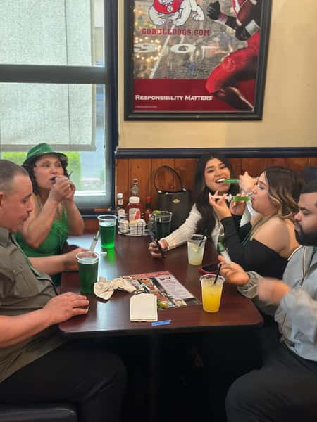 Customers having fun enjoying St. Patrick’s Day drink specials at YFC Cedar.