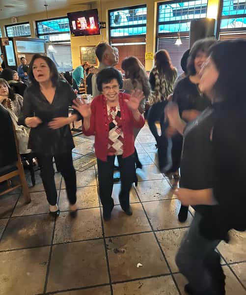 Manny's mom dancing with friends