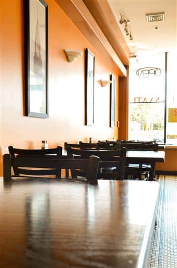 interior view of the restaurant with sun shining in on the tables and chairs