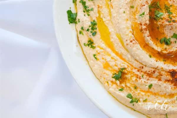 homemade hummus with parsley as a garnish