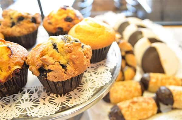 blueberry muffins on display in the bakery