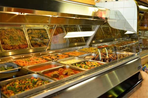 various buffet trays filled with assorted foods