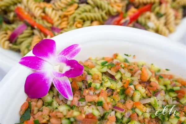 catering trays filled with different trypes of salads