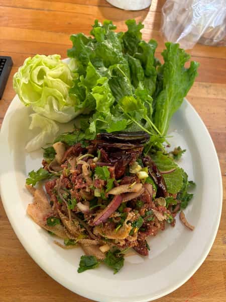 Slice beef Mixed with Mint, Cilantro, Onion, Chili , Roasted Ground Rice, Lime juice, Fish sauce, Tripea,d Add Bile serve With Lettuce, cucumber , Lime