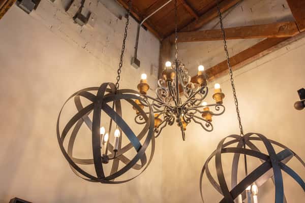 Decorative chandelier lighting with rustic metal fixtures in a cozy brewery interior
