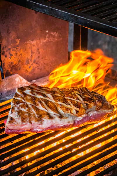 grilling meat in open flame