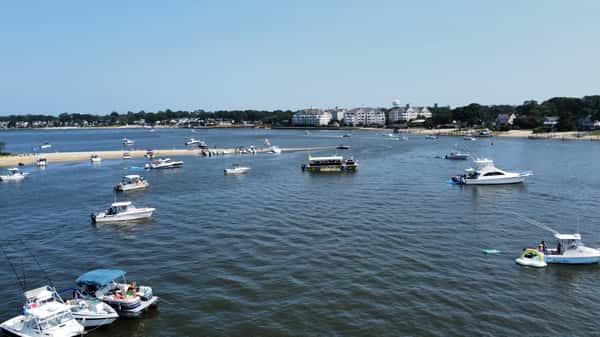 aerial shot of boat in middle of other boats