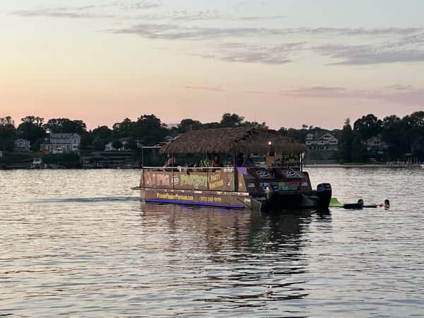 Pontoon in water rainbow sunset