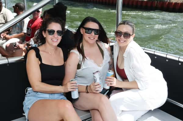 Happy customers on boat with drinks