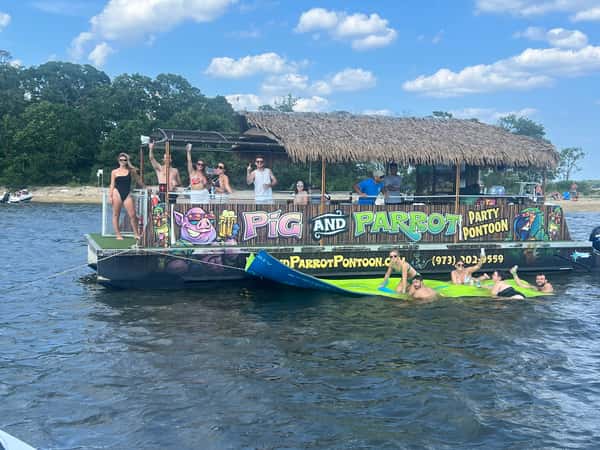 guests floating on cat and on swim mat in front of pontoon