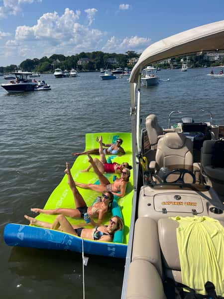 Guests on swim mat in front of the boat