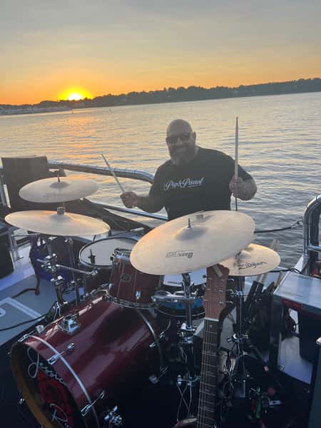 mike playing drums on boat
