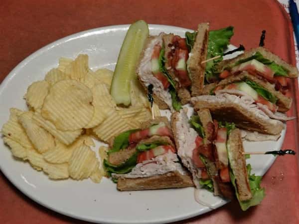 Turkey club with pickle and chips