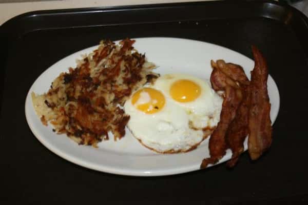 over easy eggs, bacon, and hash browns